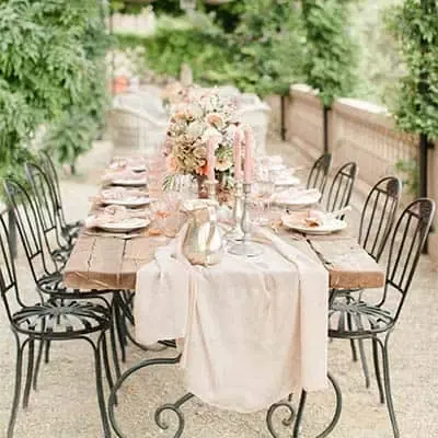 Ein Hochzeitsplaner in Oberhausen hat eine traumhafte Hochzeitstafel in einem Garten kreiert
