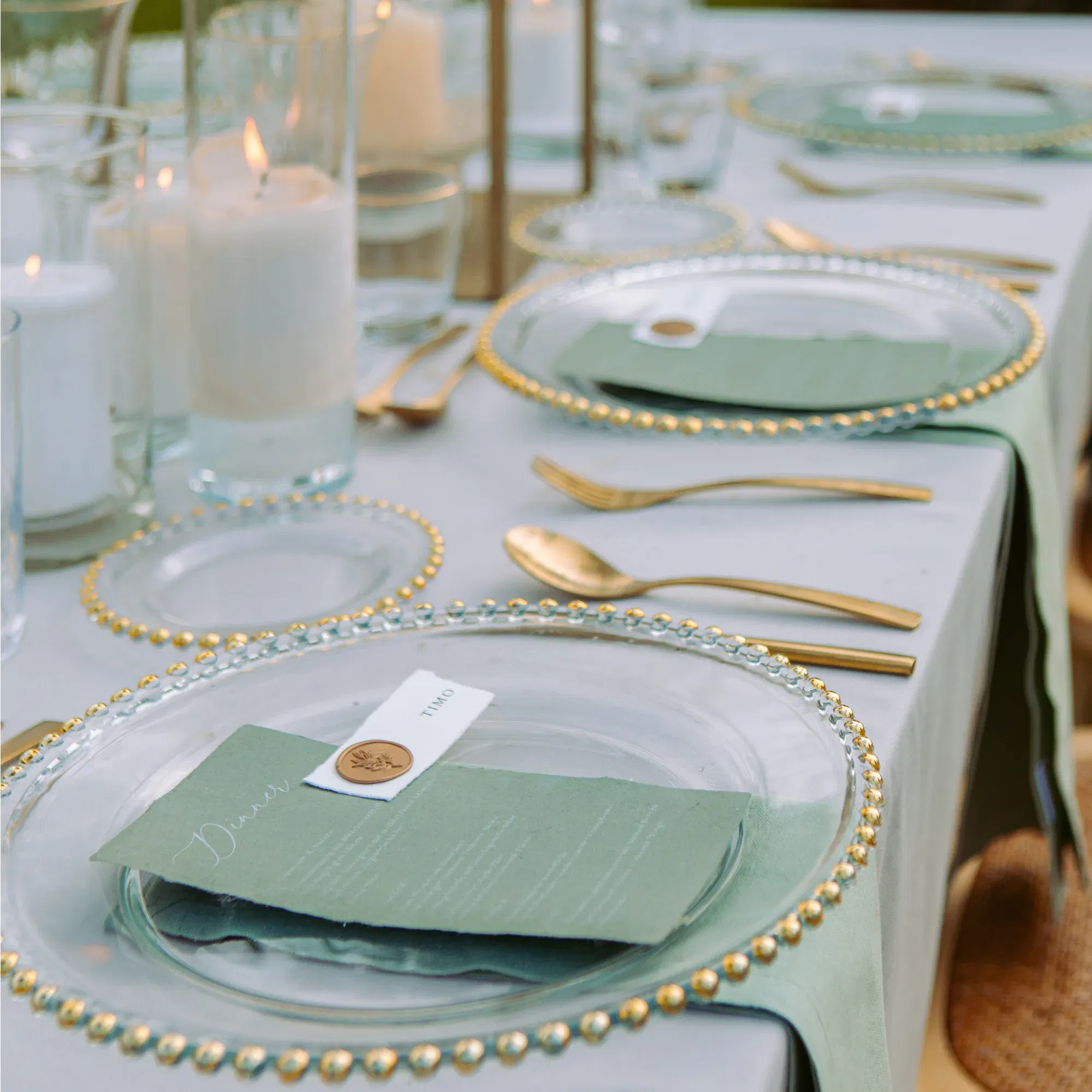 Festliche Tafel für eine Hochzeit mit Kerzen und goldenem Besteck.
