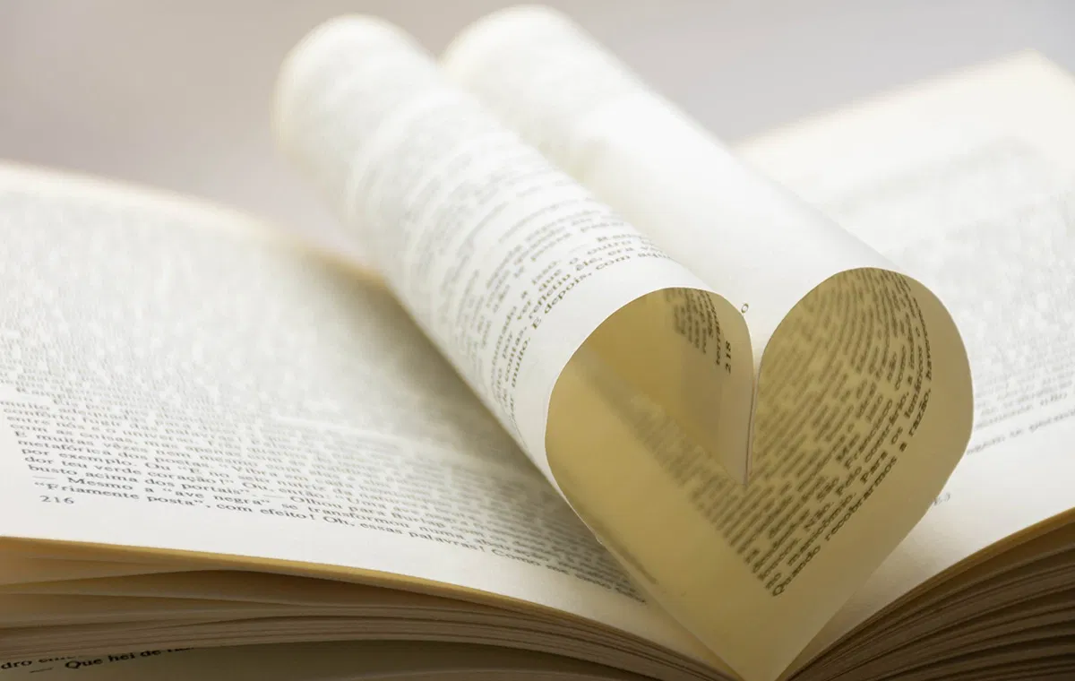 Aufgeschlagenes Buch in Herzform als Symbol für Liebe, Ehe und das Ja-Wort.